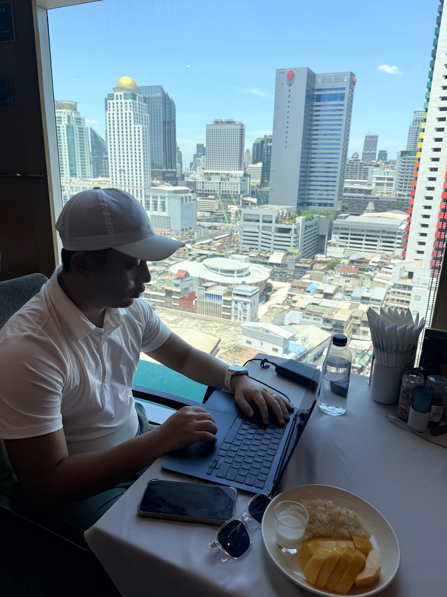 Thomas Ho working from a city office